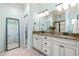 Well-lit bathroom features double sinks, granite countertops, and a large mirror at 4621 Basilica Dr, Holly Springs, NC 27540