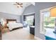 A serene bedroom with high ceilings, large windows, and comfortable furnishings at 4621 Basilica Dr, Holly Springs, NC 27540