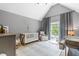 Cozy Bedroom with a crib, glider, and plenty of natural light at 4621 Basilica Dr, Holly Springs, NC 27540