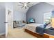 Light blue bedroom features high ceiling, cozy sitting area, and plush carpeting at 4621 Basilica Dr, Holly Springs, NC 27540