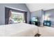 Comfortable bedroom with a large window and an entertainment center at 4621 Basilica Dr, Holly Springs, NC 27540