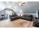 Spacious bonus room with comfortable seating, ceiling fans, and exercise equipment at 4621 Basilica Dr, Holly Springs, NC 27540