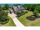 Exterior elevation of a stately home featuring a well-manicured lawn and landscaped garden beds enhancing curb appeal at 4621 Basilica Dr, Holly Springs, NC 27540