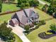Stunning two-story brick home with a beautifully landscaped front yard and inviting curb appeal at 4621 Basilica Dr, Holly Springs, NC 27540