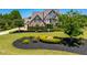Charming two-story brick home featuring a beautifully landscaped front yard and a flagpole at 4621 Basilica Dr, Holly Springs, NC 27540