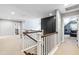 Open hallway features natural light, staircase with white railing, and view into bonus room at 4621 Basilica Dr, Holly Springs, NC 27540