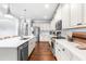 Spacious kitchen with stainless steel appliances, marble countertops, and white cabinets at 4621 Basilica Dr, Holly Springs, NC 27540