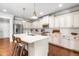 Kitchen with island, stainless appliances, white cabinets, and modern countertops at 4621 Basilica Dr, Holly Springs, NC 27540