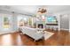 Cozy living room featuring hardwood floors, a fireplace, and plenty of natural light at 4621 Basilica Dr, Holly Springs, NC 27540