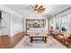 Spacious living room with hardwood floors, white sofa, and open floor plan to the kitchen at 4621 Basilica Dr, Holly Springs, NC 27540