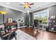 Stylish home office featuring gray walls, hardwood floors, and a large window with natural light at 4621 Basilica Dr, Holly Springs, NC 27540