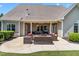 Outdoor patio features covered space, comfortable seating, and an outdoor kitchen at 4621 Basilica Dr, Holly Springs, NC 27540