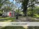 Backyard area with a firepit, seating and mature trees at 4720 Rivermont Rd, Durham, NC 27712