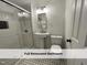 Nicely renovated full bathroom featuring a tiled shower with glass door, a pedestal sink, and modern fixtures at 4720 Rivermont Rd, Durham, NC 27712