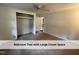 Bedroom with neutral carpet and trim showcases a spacious closet and interior door at 4720 Rivermont Rd, Durham, NC 27712