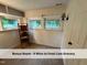 Well-lit bonus room features natural light from two windows, fresh carpet, and sconce lighting at 4720 Rivermont Rd, Durham, NC 27712