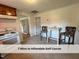 Efficient kitchen with an electric range stove and dining area featuring floral upholstered chairs at 4720 Rivermont Rd, Durham, NC 27712