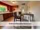 Inviting kitchen with wooden cabinets, tile backsplash, and breakfast area with floral upholstered chairs at 4720 Rivermont Rd, Durham, NC 27712