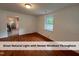 Sunlit living room featuring gleaming hardwood floors and fresh paint at 4720 Rivermont Rd, Durham, NC 27712