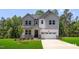 Beautiful two-story home featuring gray and white siding, a covered porch, and a spacious two-car garage at 4824 Bristol Meadow Dr, Raleigh, NC 27603