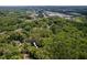 Aerial view of 4909 Brookhaven surrounded by mature trees in a neighborhood at 4909 Brookhaven Dr, Raleigh, NC 27612