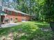 Expansive backyard featuring well-maintained lawn and mature trees for privacy at 4909 Brookhaven Dr, Raleigh, NC 27612