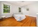 Bright bedroom with hardwood floors, two large windows, and light-colored walls at 4909 Brookhaven Dr, Raleigh, NC 27612
