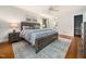 Serene bedroom with a wooden bed frame, soft colors, and hardwood flooring at 4909 Brookhaven Dr, Raleigh, NC 27612