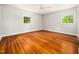 A bright bedroom with hardwood flooring and two windows providing natural light at 4909 Brookhaven Dr, Raleigh, NC 27612