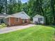 Charming brick home with manicured lawn, mature trees, and detached garage at 4909 Brookhaven Dr, Raleigh, NC 27612