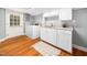 Functional laundry room with modern appliances, cabinets, and wooden flooring at 4909 Brookhaven Dr, Raleigh, NC 27612