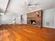 Spacious living room with hardwood floors and a cozy brick fireplace at 4909 Brookhaven Dr, Raleigh, NC 27612