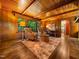 Charming living room with wood-paneled walls, beamed ceiling, and bright windows at 4909 Brookhaven Dr, Raleigh, NC 27612
