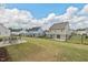 A well-kept backyard featuring a grassy lawn, a black metal fence, and patio seating perfect for enjoying outdoor living at 509 Rain Drizzle Ct, Wake Forest, NC 27587