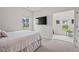 Serene bedroom featuring a mounted TV, with an office area in the adjacent room at 509 Rain Drizzle Ct, Wake Forest, NC 27587