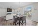 Open-concept dining area with modern lighting, hardwood floors, and comfortable seating at 509 Rain Drizzle Ct, Wake Forest, NC 27587