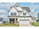 Beautiful two-story home with white siding, black shutters, and an attached two-car garage at 509 Rain Drizzle Ct, Wake Forest, NC 27587