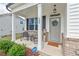 Inviting front porch with seating area, welcoming wreath, and charming 'welcome home' rug at 509 Rain Drizzle Ct, Wake Forest, NC 27587