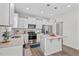 Bright kitchen with stainless steel appliances, island and white subway tile backsplash at 509 Rain Drizzle Ct, Wake Forest, NC 27587
