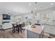 Open-concept kitchen and dining area featuring stainless appliances and stylish light fixtures at 509 Rain Drizzle Ct, Wake Forest, NC 27587