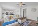 Comfortable living room featuring an open floor plan, hardwood floors, and modern decor at 509 Rain Drizzle Ct, Wake Forest, NC 27587