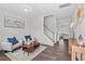 Bright living room featuring stylish decor, hardwood floors, and an open staircase at 509 Rain Drizzle Ct, Wake Forest, NC 27587