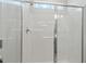 Close up of a white shower with glass door and chrome fixtures at 509 Rain Drizzle Ct, Wake Forest, NC 27587