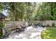 Entertaining backyard featuring an outdoor kitchen, dining area, fire pit, lush lawn, and privacy fence at 517 Bart St, Raleigh, NC 27610