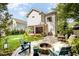 Spacious backyard with a stone patio, fire pit, lush lawn, and a covered porch, ideal for entertaining at 517 Bart St, Raleigh, NC 27610