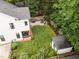 Aerial shot of backyard, featuring a well-maintained lawn, patio with seating, and fire pit at 517 Bart St, Raleigh, NC 27610