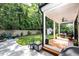 Inviting backyard with a covered deck, stone patio, fire pit, and privacy fence, perfect for outdoor gatherings at 517 Bart St, Raleigh, NC 27610