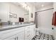 Bright bathroom with double vanity, a walk-in shower, and stylish patterned floor tiles at 517 Bart St, Raleigh, NC 27610