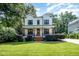 Beautiful two-story home with a charming front porch, lush landscaping, and well-maintained lawn at 517 Bart St, Raleigh, NC 27610