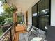 Inviting front porch featuring cozy seating, hanging plants, and a stylish outdoor space at 517 Bart St, Raleigh, NC 27610